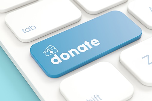 close up of computer keyboard with a blue donate button