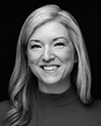 Black and white photo of a smiling woman with long hair.