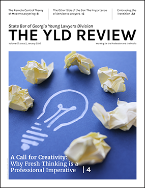 Cover of the YLD newsletter featuring a drawing of a light bulb on a field of blue surrounded by light yellow wads of paper.